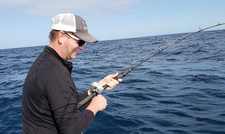 Holding Fishing Rod Photos and Images